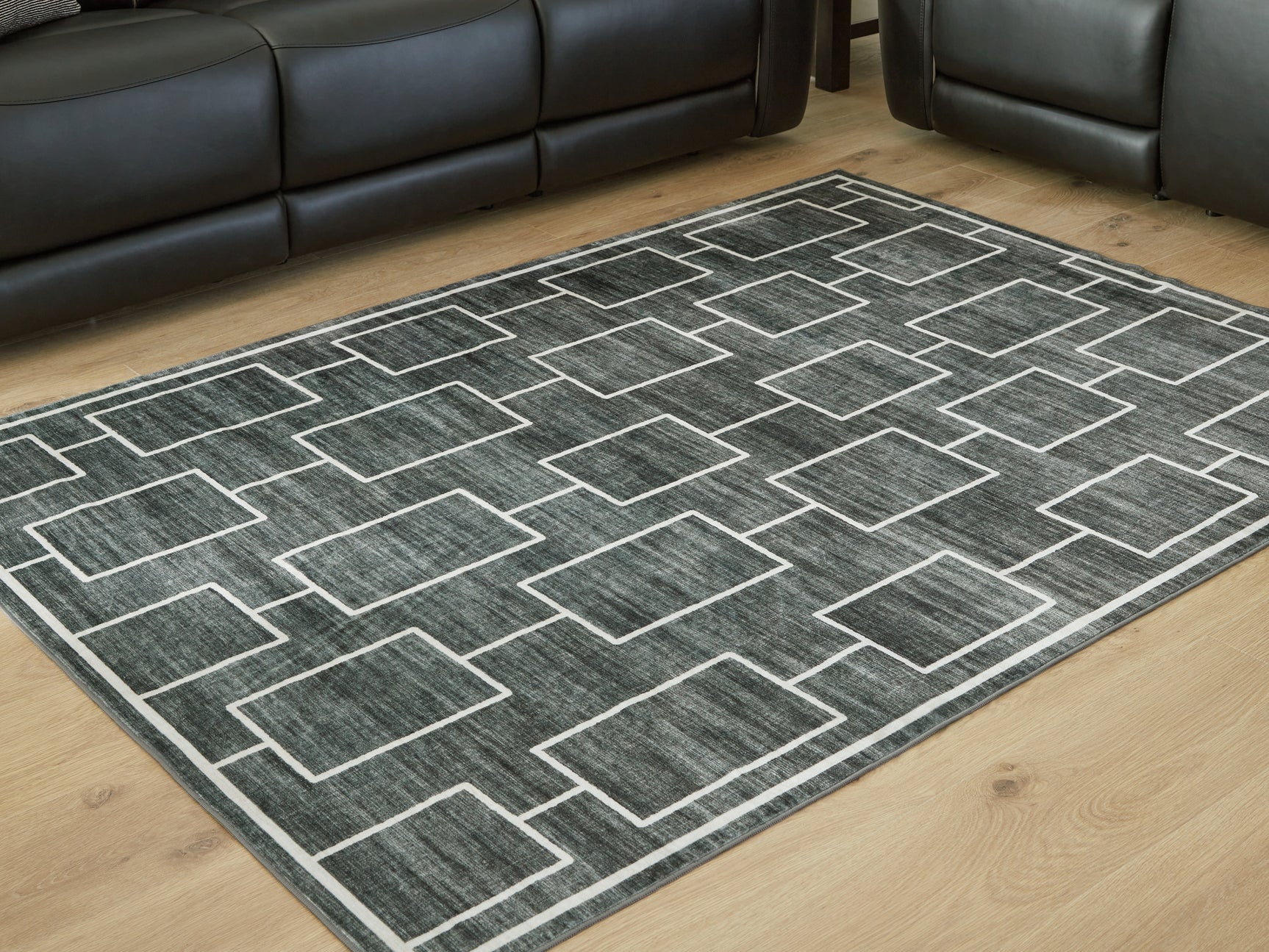 Tampa Furniture Outlet - Ashley Furniture - Elderland Rug - Washable 7'6" x 9'6" Area Rug / Black/Gray - R407401